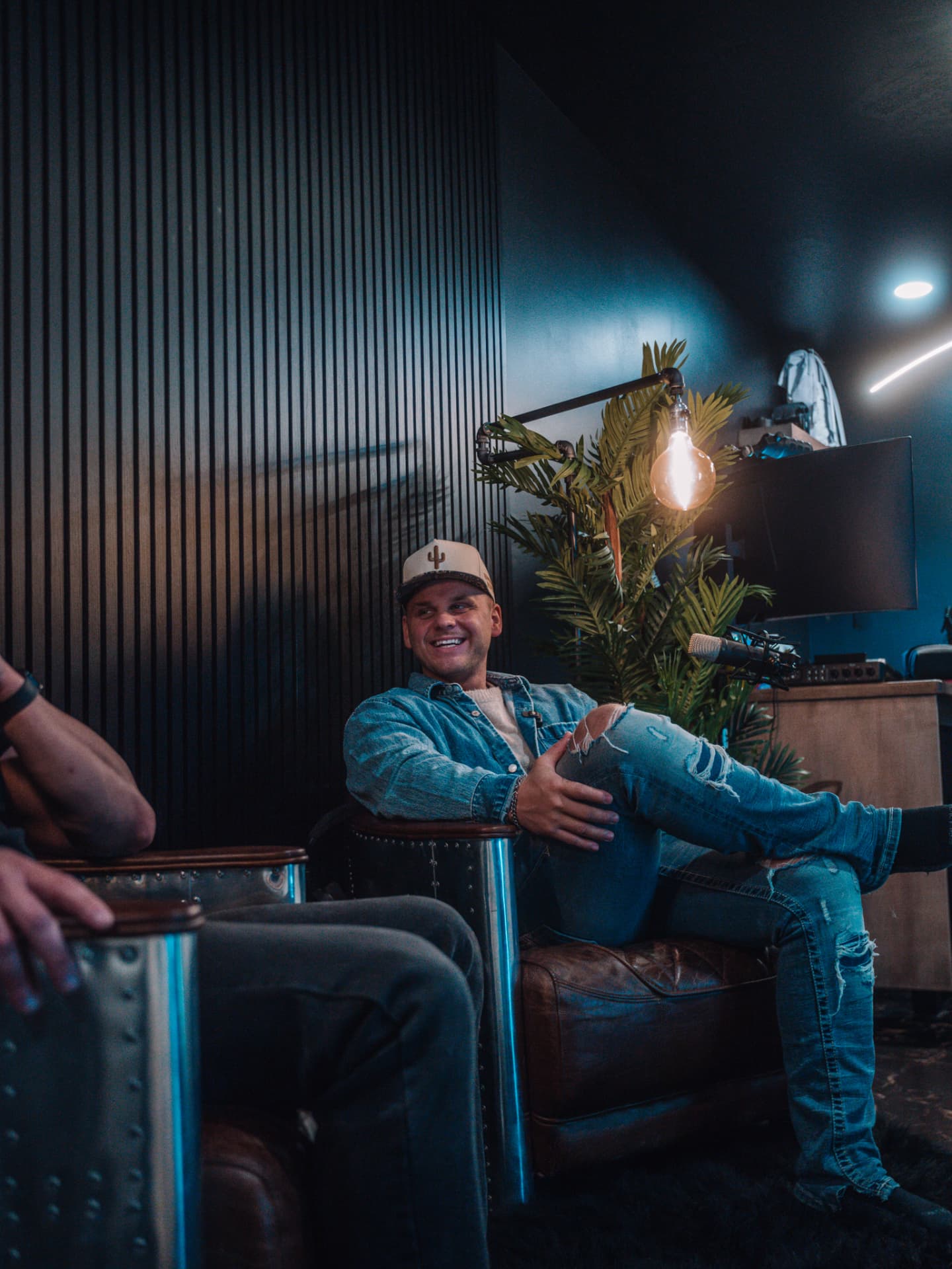 Layne, co-founder of RüS, laughing in the studio chair