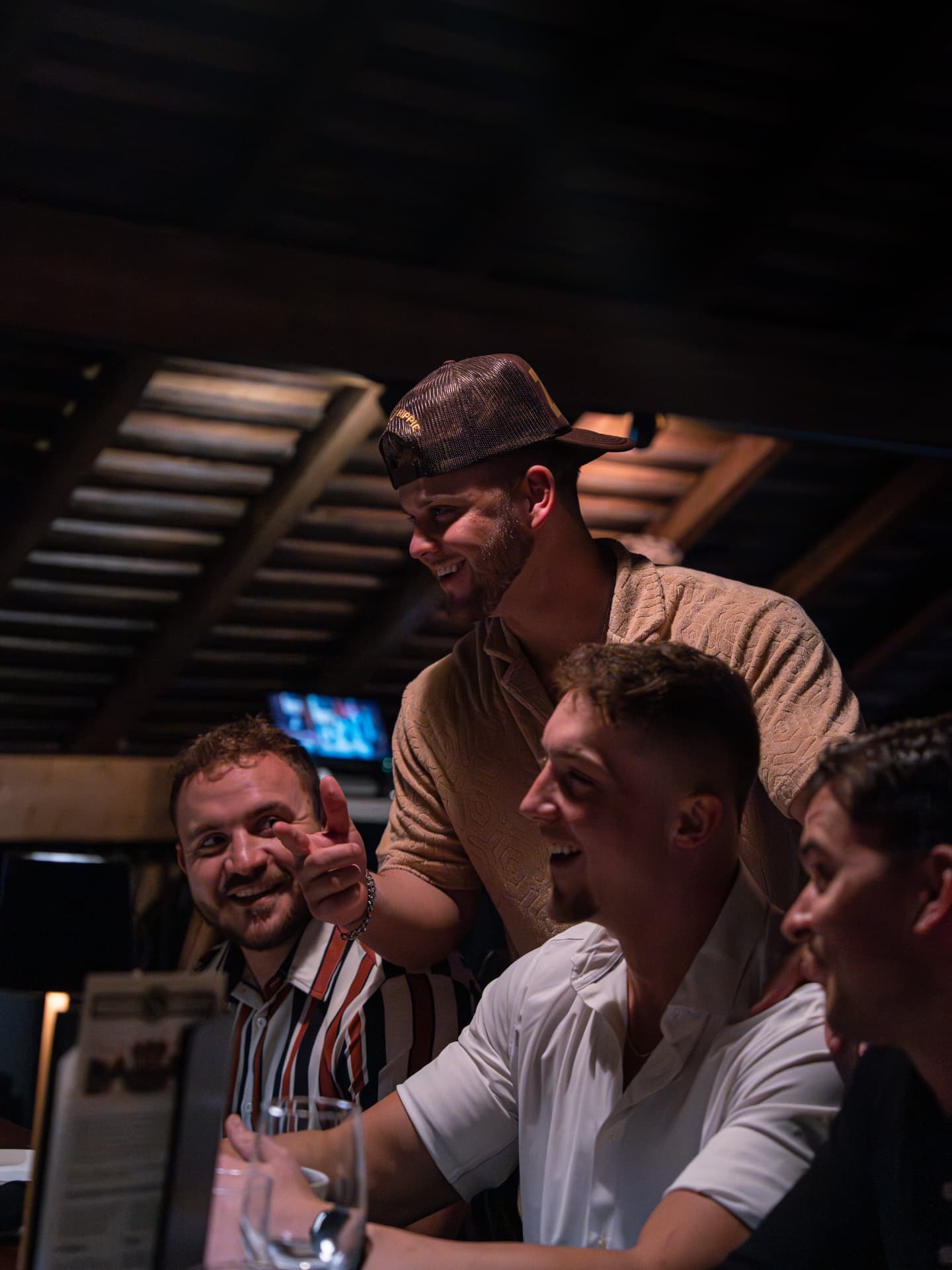 Tyler, Zach and Layne laughing together at a table