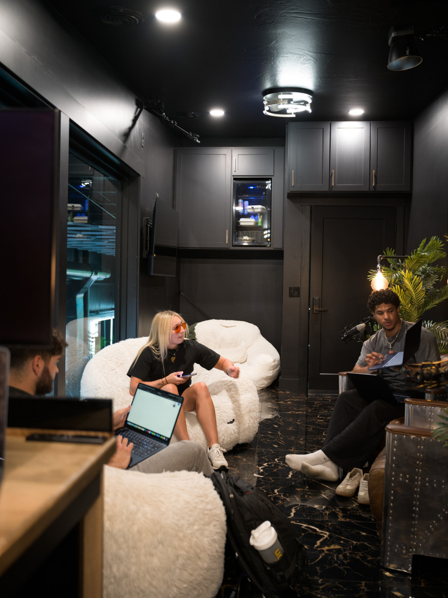 The RüS crew working on laptops in the studio lounge